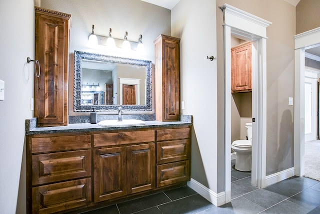 2030 Silver Creek Ct, San Angelo, TX 76904 - bathroom with toilet, vanity, tile patterned flooring, and baseboards