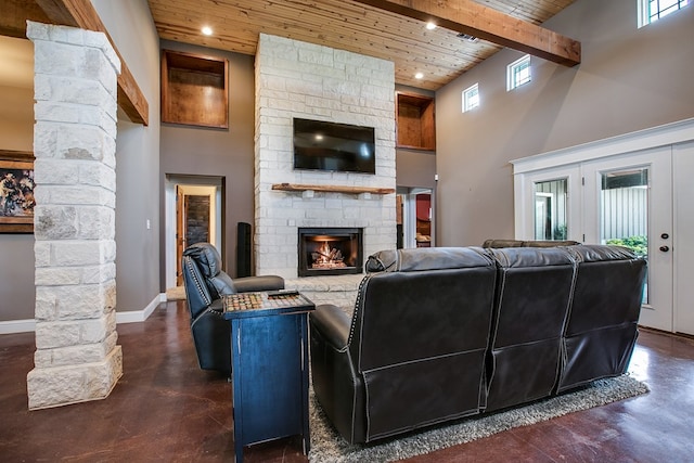 2030 Silver Creek Ct, San Angelo, TX 76904 - living room featuring wooden ceiling with exposed beams, a fireplace, decorative columns, a high ceiling, and baseboards