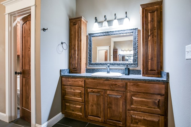 2030 Silver Creek Ct, San Angelo, TX 76904 - bathroom featuring vanity, tile patterned floors, toilet, and baseboards