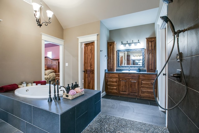 2030 Silver Creek Ct, San Angelo, TX 76904 - ensuite bathroom featuring vanity, a garden tub, vaulted ceiling, and tile patterned flooring