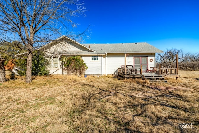 back of house featuring a wooden deck