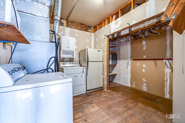 washroom featuring hardwood / wood-style floors and washer and dryer