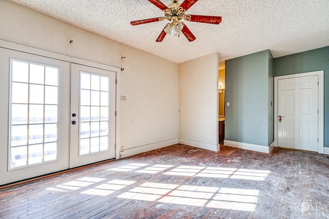 interior space featuring french doors, ceiling fan, and a textured ceiling