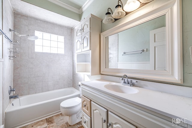 full bathroom featuring crown molding, vanity, toilet, and tiled shower / bath combo