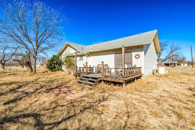 back of property featuring a wooden deck