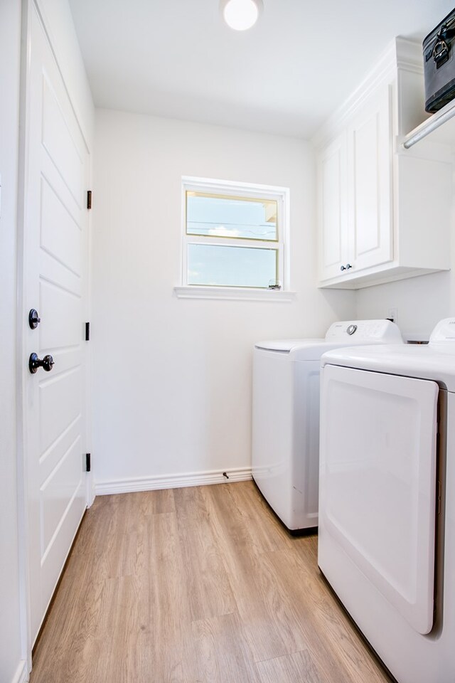 909 E 39th St, San Angelo, TX 76903 - laundry area with washing machine and clothes dryer, cabinet space, and light wood-style flooring