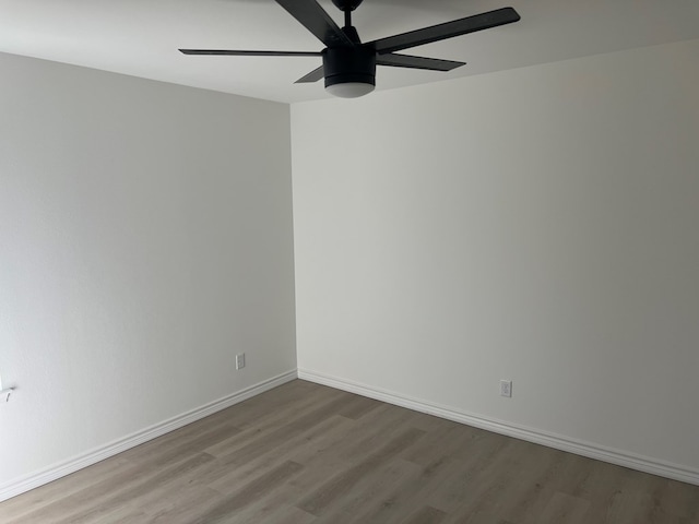 spare room featuring ceiling fan and light hardwood / wood-style flooring