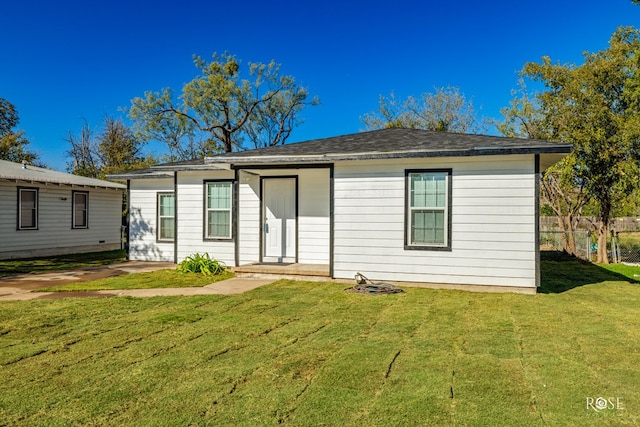 back of house with a lawn