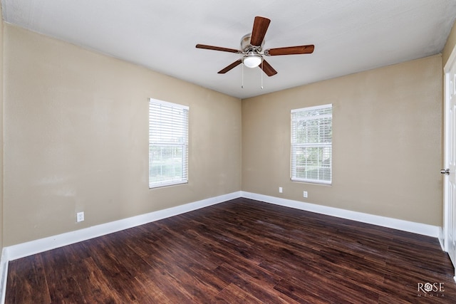 spare room with dark hardwood / wood-style floors and ceiling fan