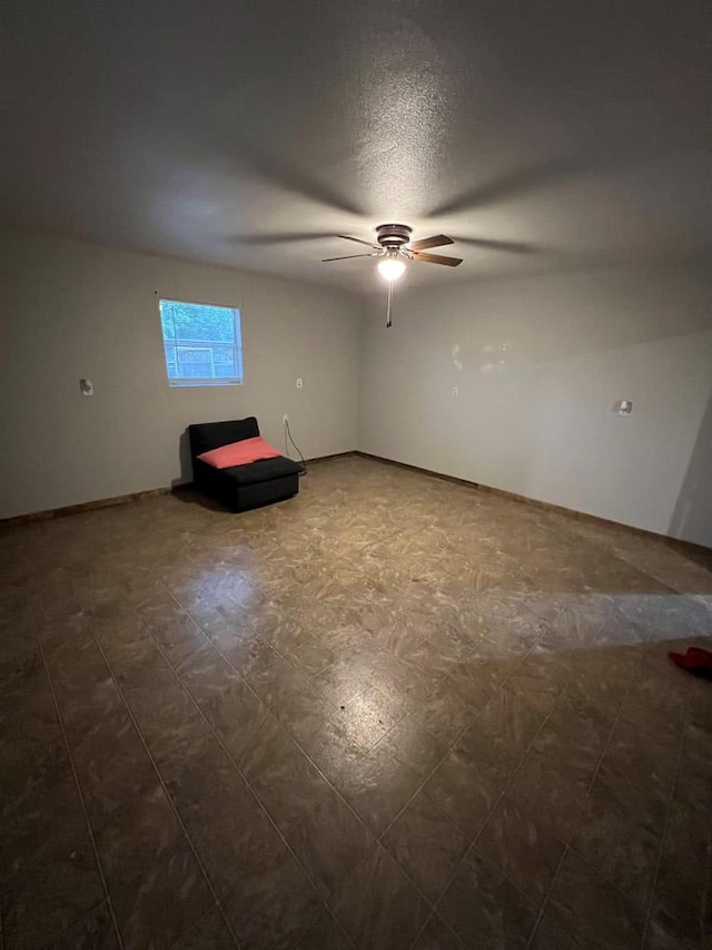 207 Ave J, Ozona, TX 76943 - unfurnished room featuring dark floors and ceiling fan