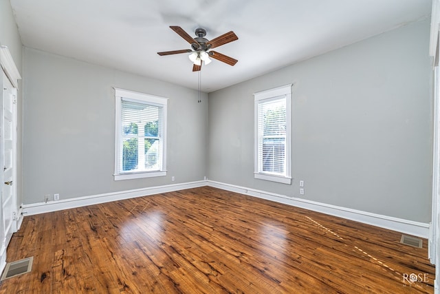 2 N Adams St, San Angelo, TX 76901 - unfurnished room with healthy amount of natural light, a ceiling fan, and dark wood-type flooring