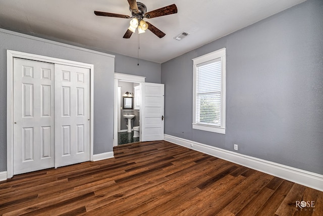 2 N Adams St, San Angelo, TX 76901 - unfurnished bedroom featuring dark wood-type flooring, a closet, ensuite bath, and ceiling fan