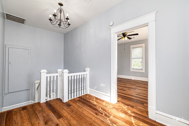 2 N Adams St, San Angelo, TX 76901 - hallway with an upstairs landing, wood finished floors, a chandelier, and attic access