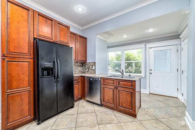 2 N Adams St, San Angelo, TX 76901 - kitchen featuring black fridge, stainless steel dishwasher, ornamental molding, light countertops, and decorative backsplash