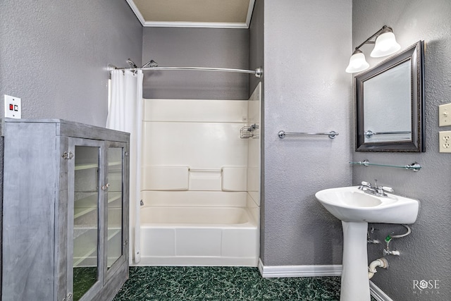 2 N Adams St, San Angelo, TX 76901 - bathroom featuring bathtub / shower combination, a textured wall, and crown molding