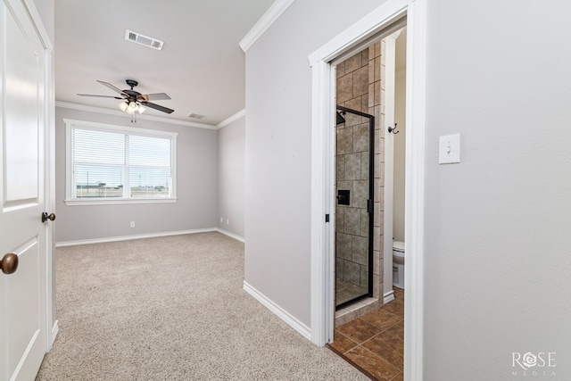 corridor with visible vents, carpet floors, baseboards, and crown molding