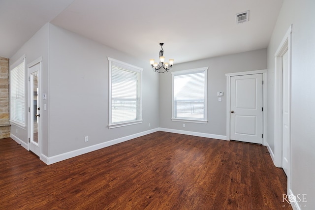 unfurnished dining area with an inviting chandelier, baseboards, visible vents, and dark wood-style flooring