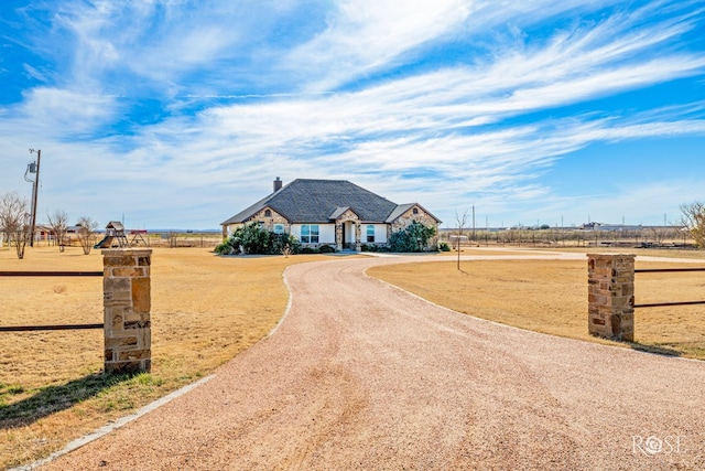 french provincial home featuring dirt driveway