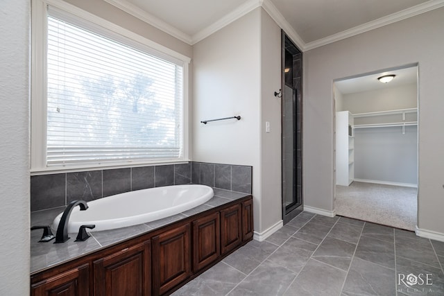 bathroom featuring a spacious closet, a shower stall, a bath, and ornamental molding