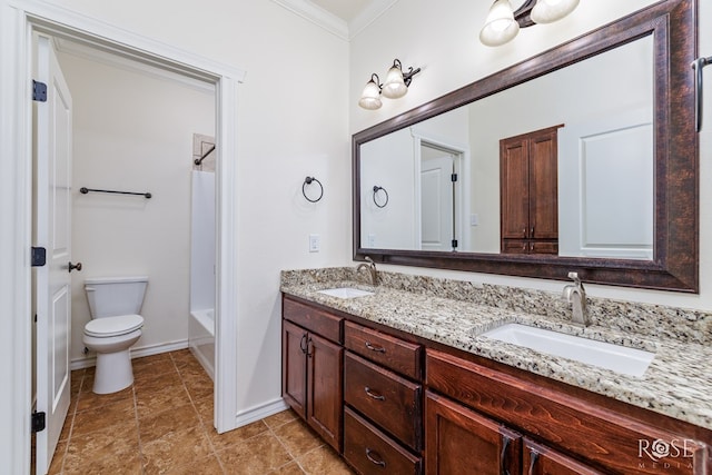 full bathroom featuring double vanity, toilet, crown molding, and a sink