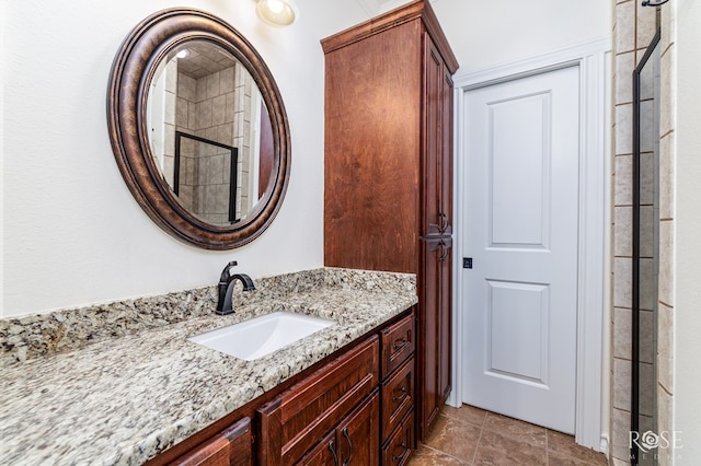 full bathroom featuring vanity and a tile shower