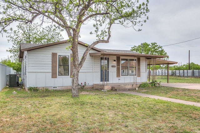 single story home with central AC, driveway, covered porch, fence, and a front yard