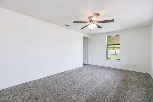 unfurnished room with baseboards, a ceiling fan, visible vents, and carpet