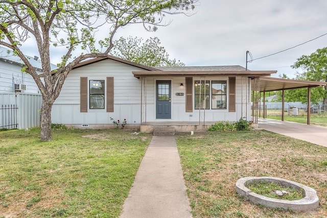 view of front of home featuring fence, a front yard, a carport, and concrete driveway