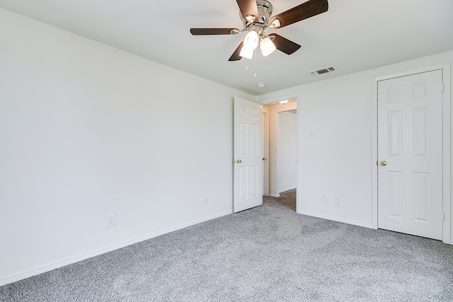 unfurnished bedroom with ceiling fan, baseboards, carpet flooring, and visible vents