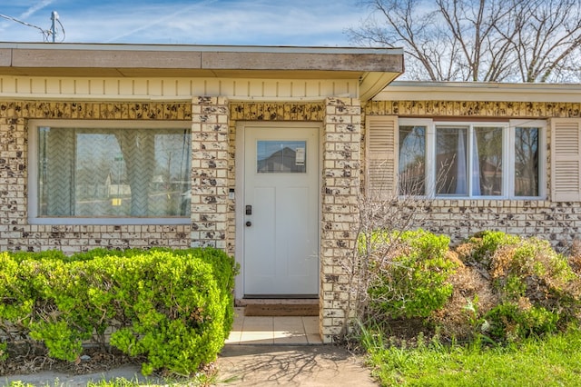 property entrance featuring stone siding