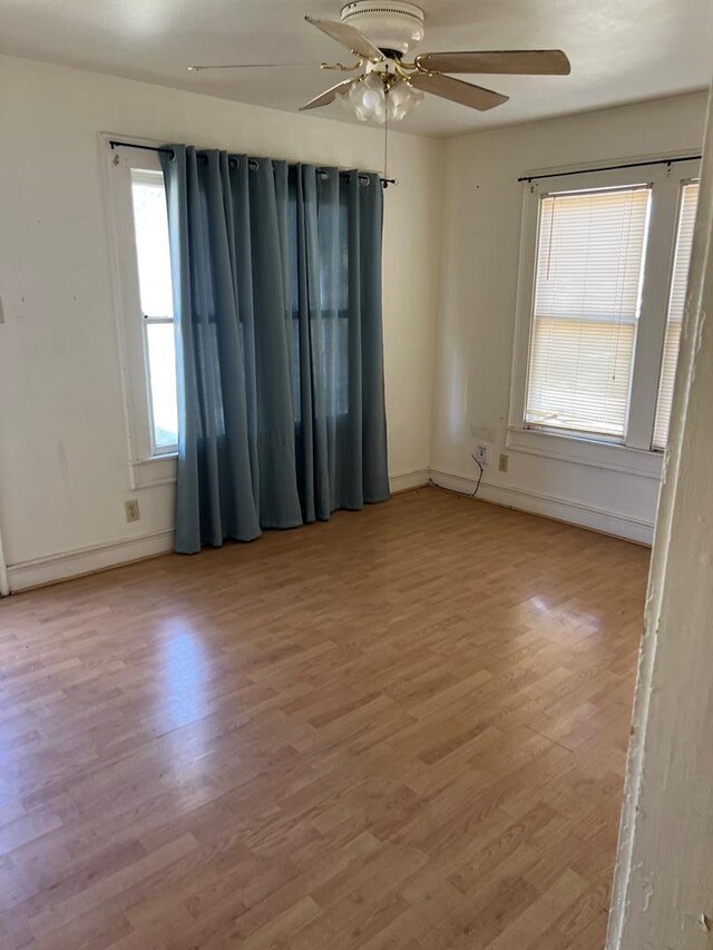 2319 W Beauregard Ave, San Angelo, TX 76901 - spare room featuring ceiling fan, light wood-style flooring, and baseboards