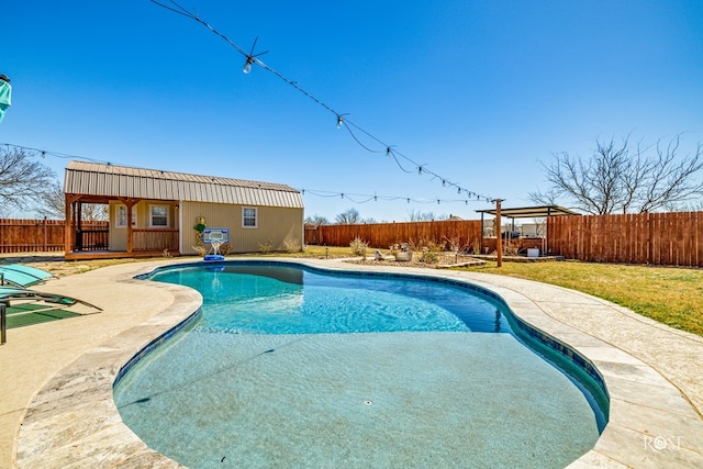 view of swimming pool with a fenced in pool, a storage structure, a fenced backyard, an outbuilding, and a patio