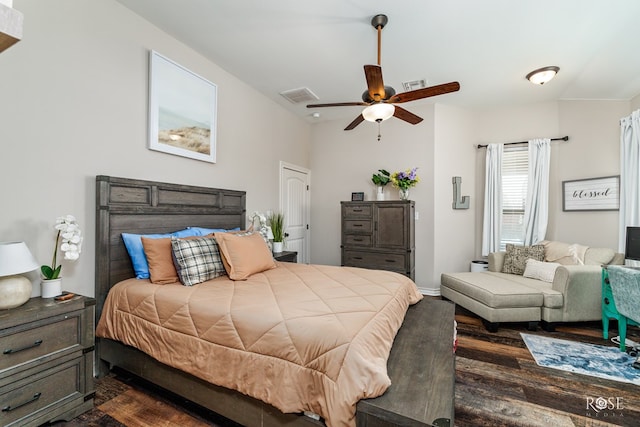 bedroom featuring visible vents, baseboards, dark wood-type flooring, and ceiling fan