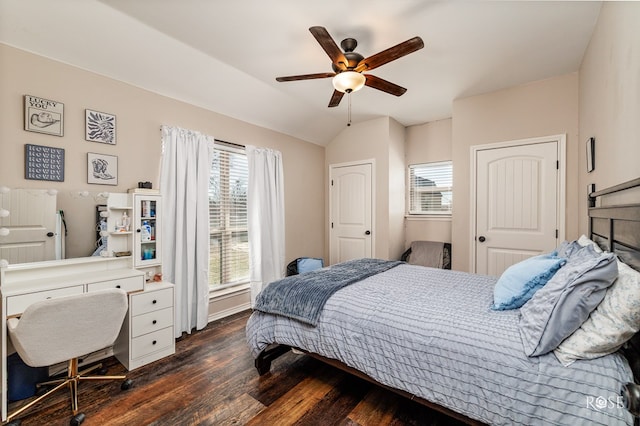 bedroom with dark wood finished floors, a ceiling fan, and lofted ceiling