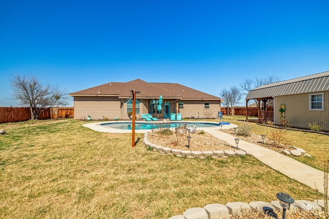 back of property featuring a fenced in pool, a patio, a lawn, and a fenced backyard