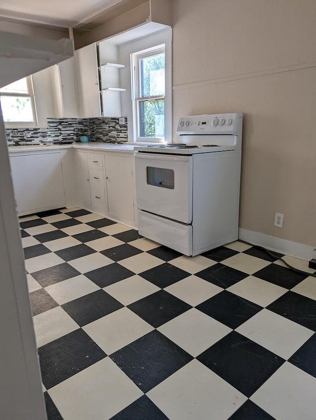 kitchen with open shelves, white electric range oven, a healthy amount of sunlight, and light countertops