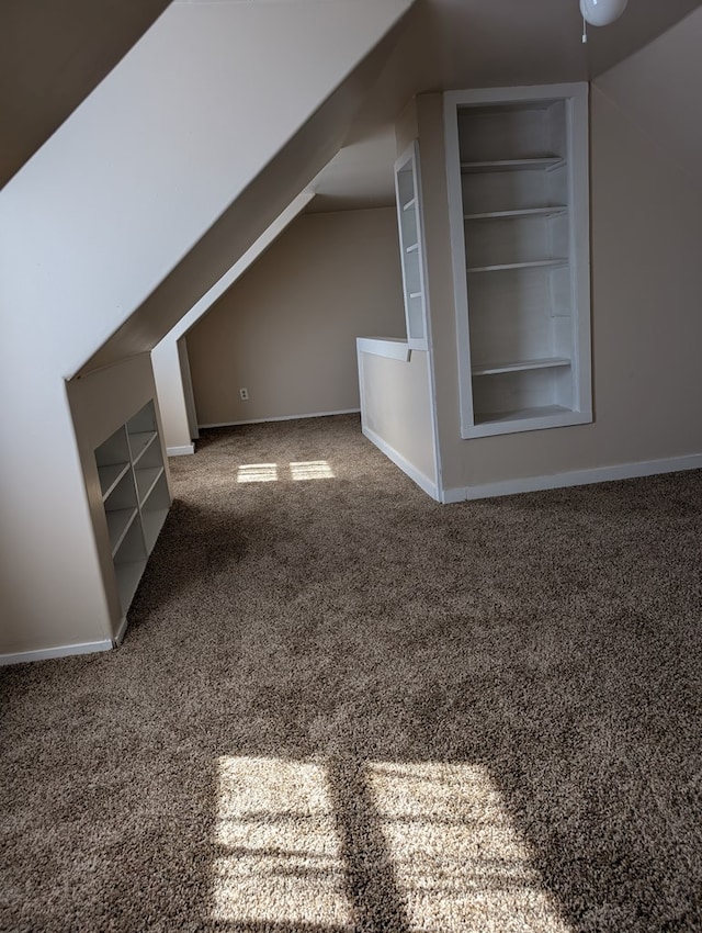 718 N Adams Ave, San Angelo, TX 76901 - additional living space featuring carpet flooring, baseboards, built in shelves, and lofted ceiling