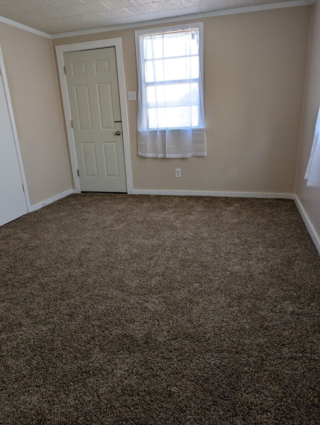 unfurnished room featuring carpet floors and baseboards
