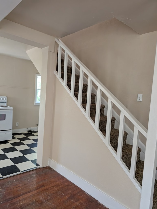 staircase with baseboards and tile patterned floors