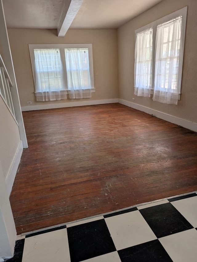 unfurnished room with baseboards, beamed ceiling, stairs, and hardwood / wood-style floors