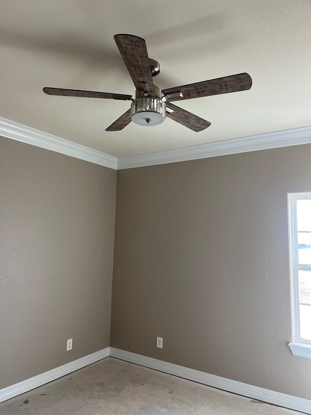 spare room featuring concrete flooring, ornamental molding, and ceiling fan