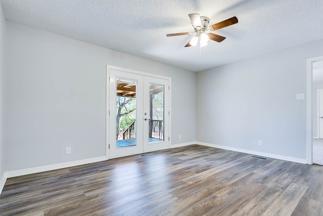 unfurnished room featuring dark wood-type flooring, french doors, and a textured ceiling