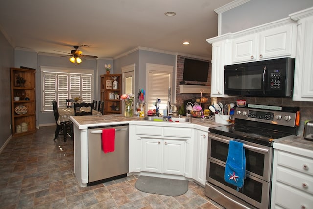 10581 Ballard Rd, San Angelo, TX 76901 - kitchen with appliances with stainless steel finishes, ceiling fan, stone finish floors, tile countertops, and ornamental molding