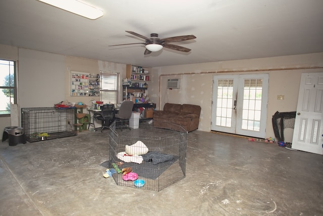 10581 Ballard Rd, San Angelo, TX 76901 - living area featuring french doors, unfinished concrete flooring, a ceiling fan, an AC wall unit, and healthy amount of natural light