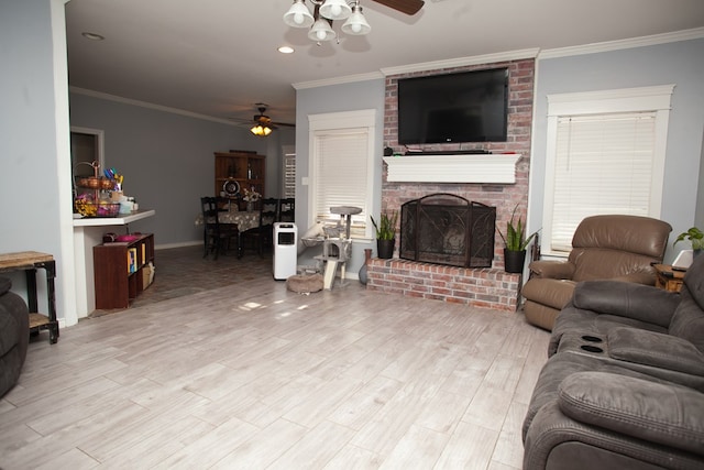 10581 Ballard Rd, San Angelo, TX 76901 - living room with a ceiling fan, ornamental molding, a fireplace, light wood-type flooring, and baseboards