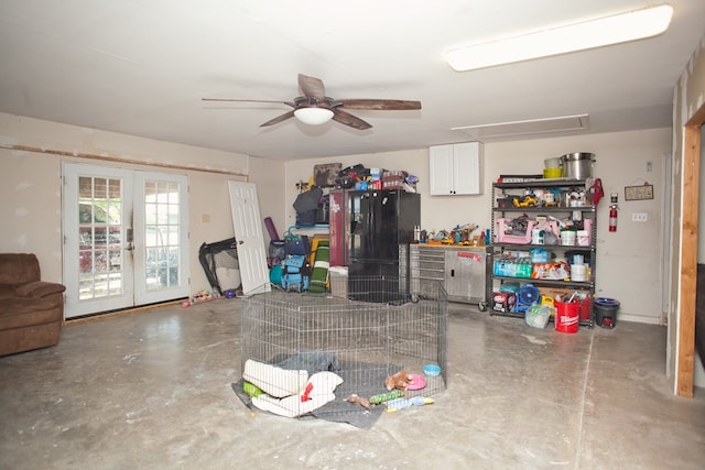 10581 Ballard Rd, San Angelo, TX 76901 - garage featuring french doors, black fridge with ice dispenser, and a ceiling fan