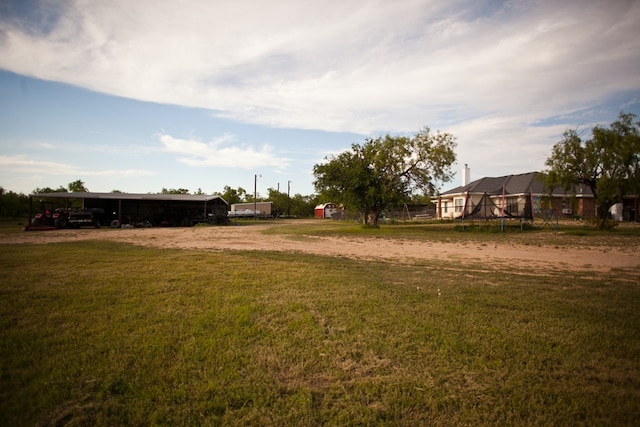 10581 Ballard Rd, San Angelo, TX 76901 - view of grassy yard featuring dirt driveway and a detached carport