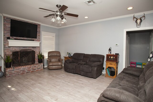 10581 Ballard Rd, San Angelo, TX 76901 - living room featuring a ceiling fan, crown molding, a fireplace, light wood finished floors, and recessed lighting
