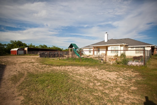 10581 Ballard Rd, San Angelo, TX 76901 - view of yard featuring fence, a playground, and an outdoor structure