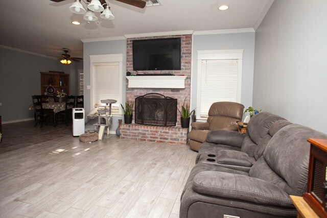 10581 Ballard Rd, San Angelo, TX 76901 - living room featuring a ceiling fan, a fireplace, ornamental molding, light wood finished floors, and baseboards